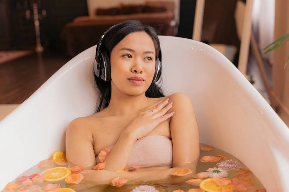 Serene bathtub with floating botanicals and oil droplets