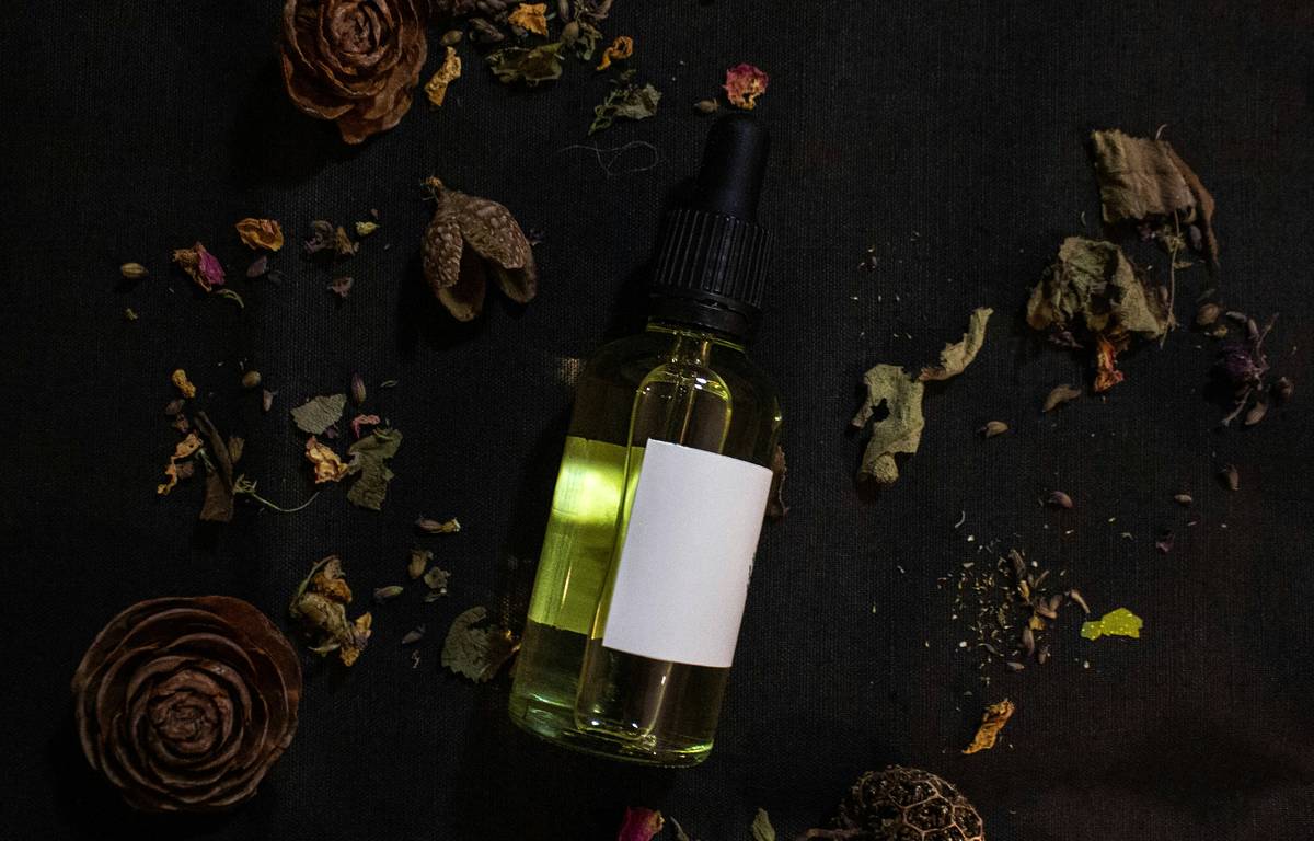 Side-by-side ingredient comparison: Bath and Body Works fragrance oil vs. cold-pressed botanical bath oil showing mineral oil vs. plant-derived oils