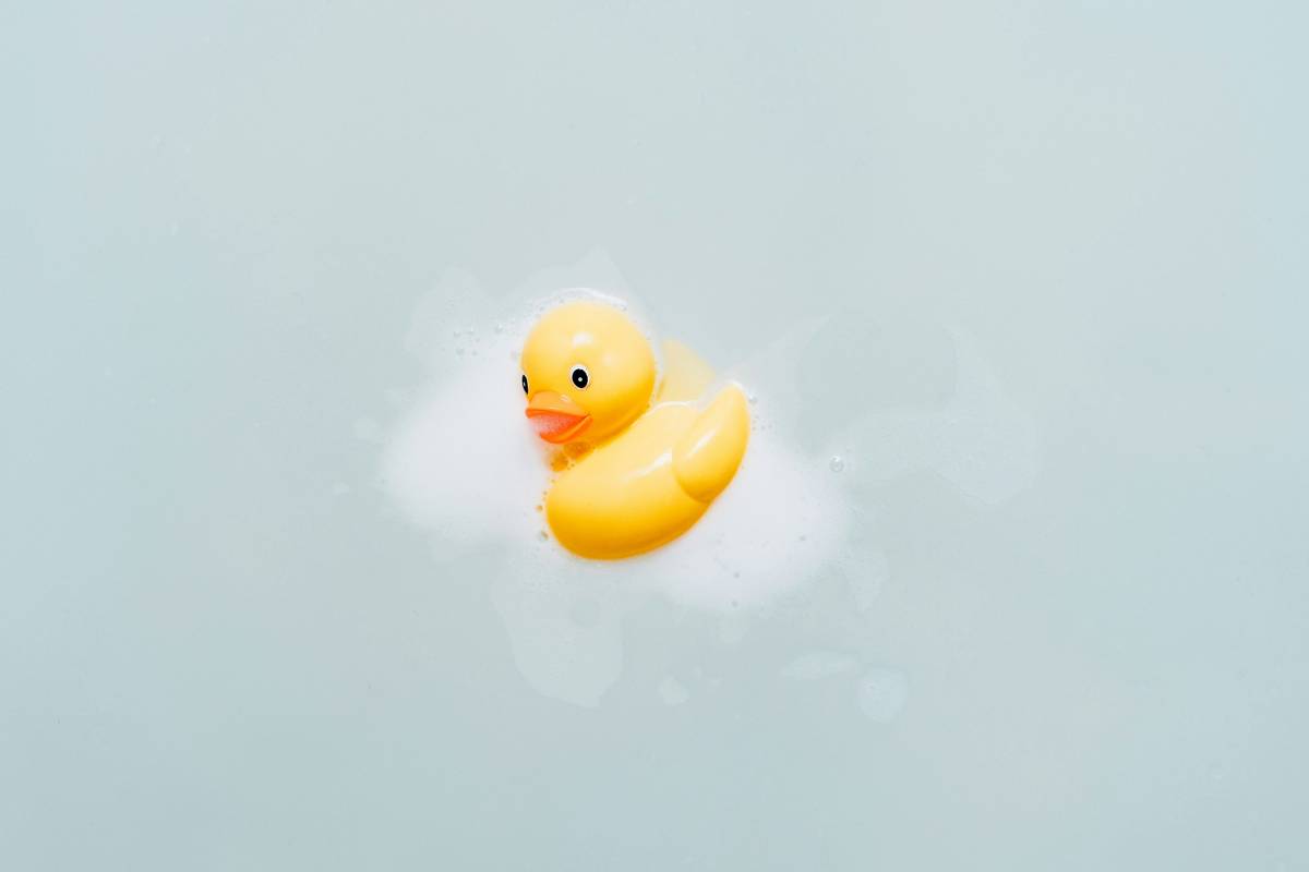 woman using aromatherapy bath oil body work lotion in bathtub